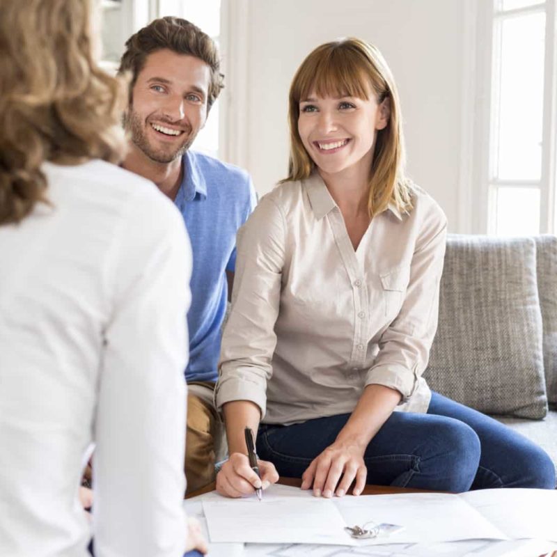 Young couple owners meeting real estate agent for house investme